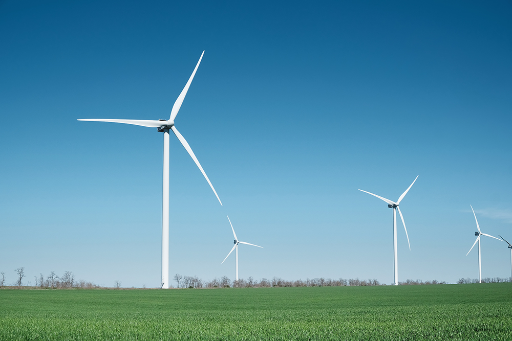 Wind power station on field. Technology and inovation. Green energy composition. Wind turbines. Industrial landscape